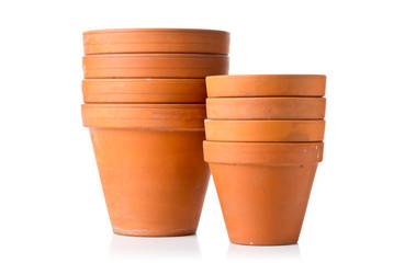 Group of empty, stacked, used terracotta planting pots over white