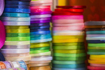 Stacks of color ribbons. Colored ribbons for decoration and gifts