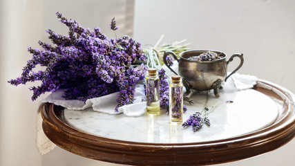 lavender oil bottles,  natural herb cosmetic consept with lavender flowers flatlay on stone...