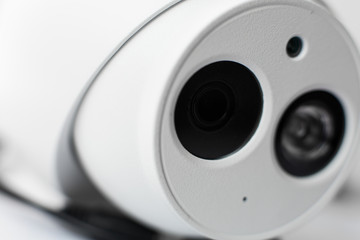 White security cctv dome type camera close-up. Lens and ir.