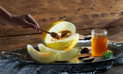 melon with honey, on a rustic wooden table