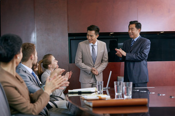 Business men and women in a meeting