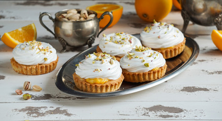 Vegan raw cheesecake with blueberry, cherry, matcha tea, orange,  cashew cream, coconut butter and coconut milk, and base made of almonds, dates  and  dried apricots, oat flakes, lyophilisated berry