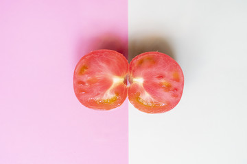 creative minimalist layout of fresh raw tomato on soft color background with knife f