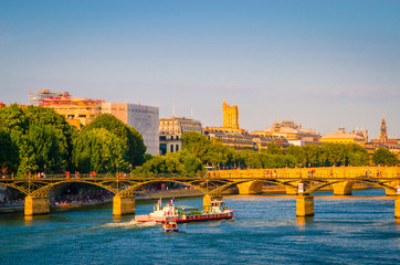 Obraz premium Sunset view on bridge Pont des Arts and buildings on the Seine river in Paris, France
