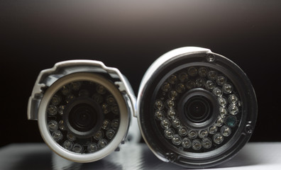 Surveillance cameras for sale photographed on a black background