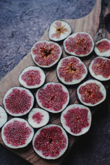 Fresh organic ripe figs on rustic wooden board. Healthy lifestyle, seasonal fruit, sweet dessert, top view