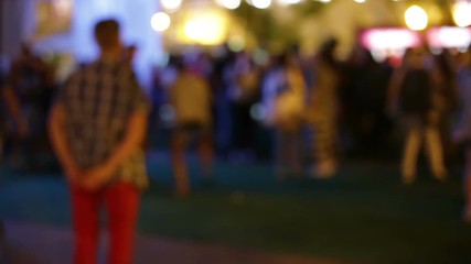 A group of people dancing at a party in a blurry style.