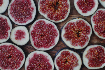 Fresh organic ripe figs on rustic wooden board. Healthy lifestyle, seasonal fruit, sweet dessert, top view