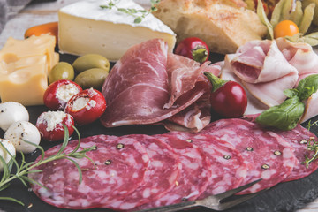 board with prosciutto, salami,bacon and cheese mozzarella ,brie,olives,home bread