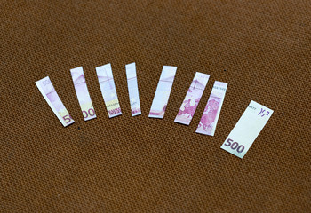 small pieces five hundred euros on a fabric background rope