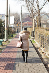 Girl walking on the path of the sidewalk