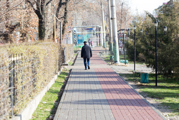 Fototapeta na wymiar a man walking in the path of the sidewalk