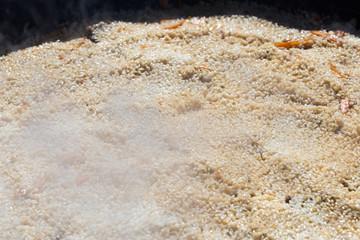 preparation of a national dish pilaf Uzbek people in the outbreak