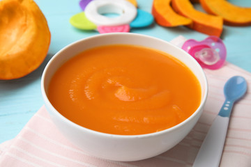 Bowl of healthy baby food on wooden table