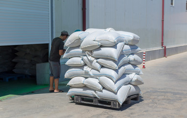 man of a warehouse worker with a manual loader