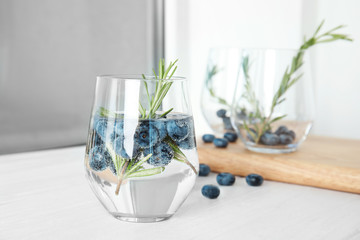 Refreshing blueberry cocktail with rosemary on table