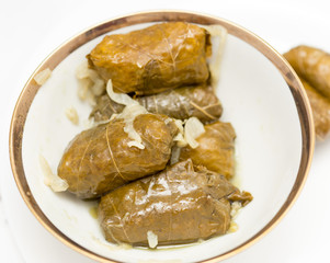 dolma, stuffed grape leaves on a white background