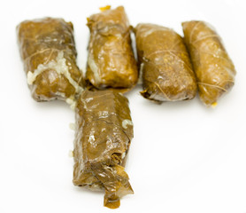 dolma, stuffed grape leaves on a white background