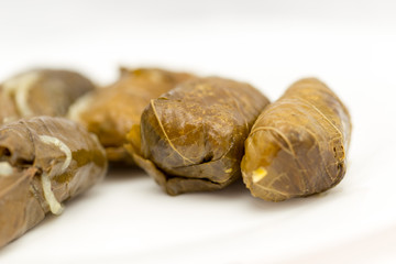 dolma, stuffed grape leaves on a white background