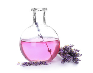 Obraz na płótnie Canvas Flask with aromatic lavender oil on white background
