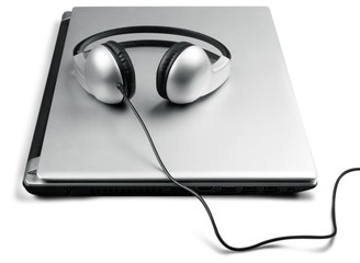 Modern latop and headphones isolated on white