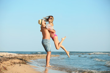 Young couple spending time together on beach