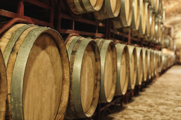 Large wooden barrels in wine cellar, closeup