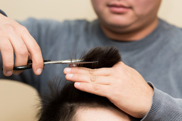 hairdresser cutting customer's hair