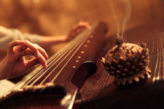 Young woman playing the lyre