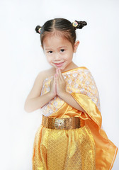 Portrait of asian child girl in traditional thai dress praying isolated on white background.