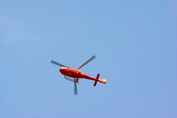 Fototapeta na wymiar Red Helicopter Low
