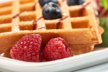 Dessert dish. Belgian waffles with ice cream, blueberries and raspberries.