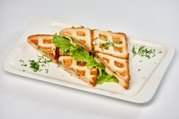 Waffle sandwich with ham and salad./Crispy sandwich with ham and salad. Breakfast.