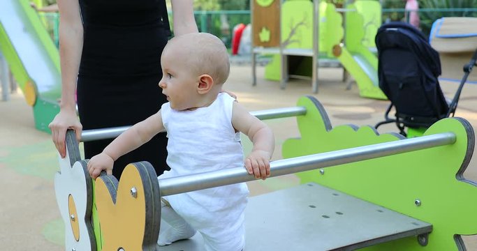 Cute Ten Month Old Baby Boy Playing At Outdoor Playground. Close Up View - DCi 4K Resolution
