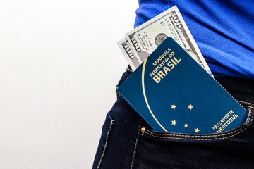 close up in Brazilian passport in a trouser bag with dollar banknotes