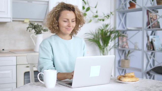 Young Woman Making Online Payment With Credit Card Using Laptop At Home.