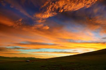 Naklejka na ściany i meble The rosy clouds of dawn on the summer grassland.