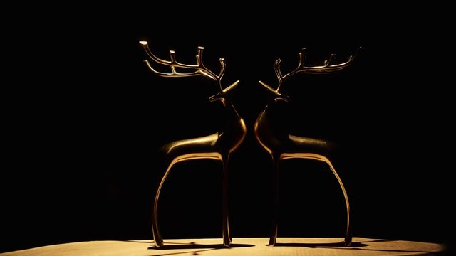 Figurines fengshui of deer rotating in halogen light