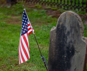the american flag and tomb stone