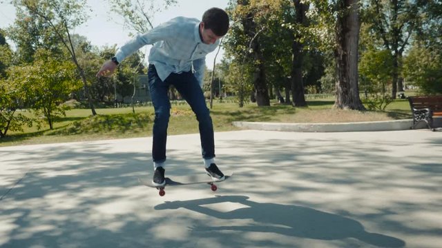 Close up of a skateboarders skater extreme trick feet while skating active teenager shot in the air on a skateboard in a skate park, street slow motion kickflip 360 flip ollie
