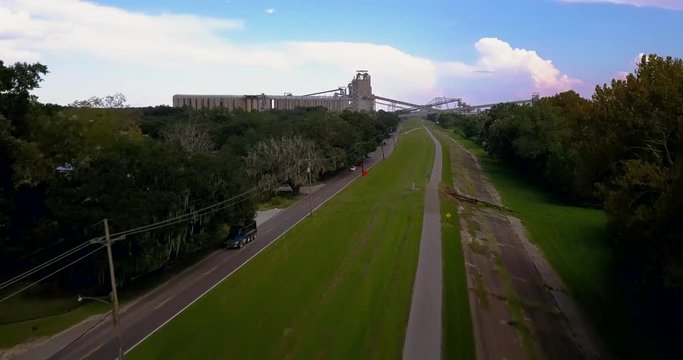 Aerial Bike Path on Levee with Factory in Background 