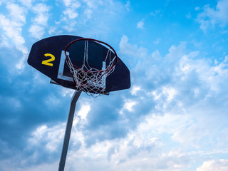 Basketball ring against the blue sky. Street sports. Basketball.