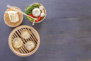 Asian steam dumplings - a traditional dish of Chinese grapes with hot vegetable appetizers. Top view. Copy space