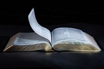 Open Bible on dark tablet