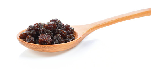 Dried raisins in spoon on white background