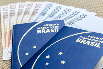 Close up on two Brazilian passports with euro banknotes