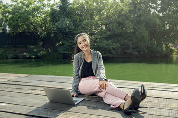 Pretty asian businesswoman using laptop while relaxing