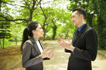 Attractive asian business people having serious conversation