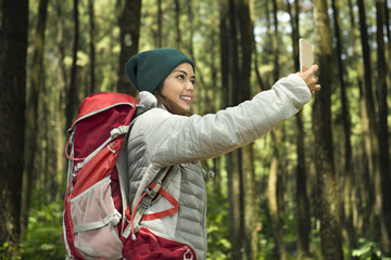 Beautiful asian tourist taking selfie with her phone